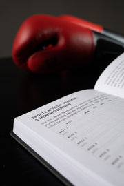 Open Focus Journal showing the Sports Activity Tracker 3-Month Overview page, with red boxing gloves in background